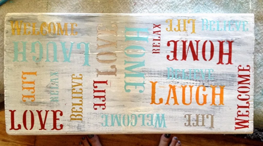 Stenciled the painted wood board that say welcome, laugh, life, and believe 