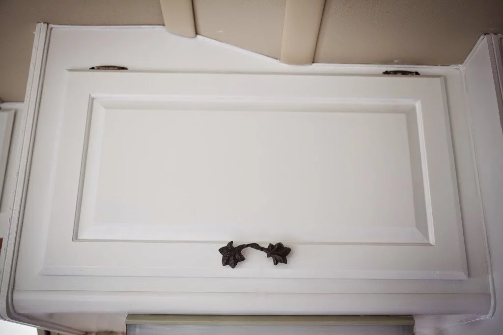 White cabinet with flower handle