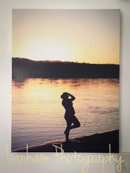 canvas photo of woman's silhouette on the river at sunset