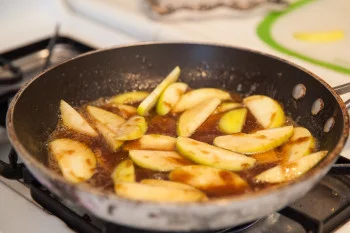 Cinnamon Apples with sauce cooking in pan 