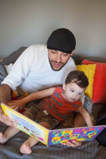 newborn lifestyle session dad and toddler reading book