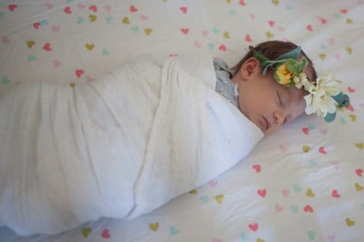 swaddled baby girl with flower crown