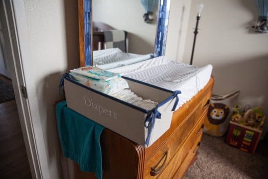 Diaper basket on dresser in nursery being used as the changing table