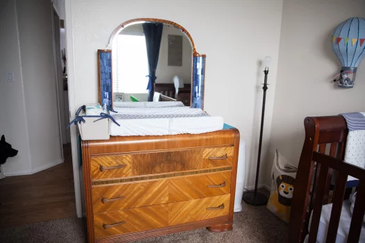 dresser in nursery being used as a changing table