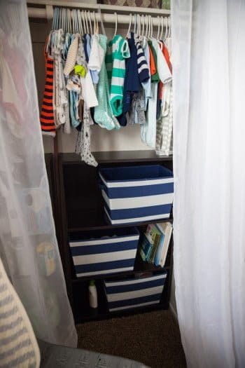 Nursery Closet Organization with clothes hanging and shelves for storage 