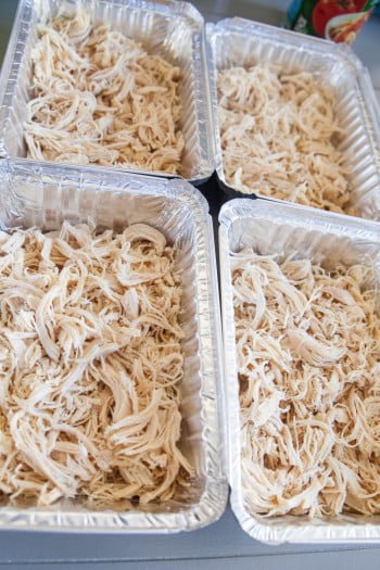 Shredded chicken in four separate containers 