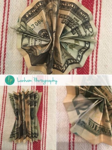 Folding the center of a twenty dollar bill 