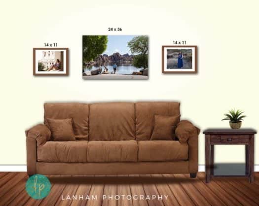 Wall Gallery with three pictures on wall, a brown couch, a side table with a plant on top, and a wood floor