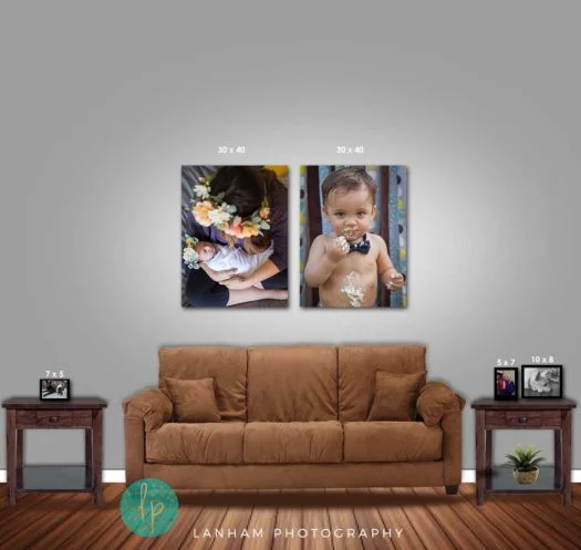 Wall Gallery with two pictures of babies hanging on wall, brown couch, two side tables with pictures on them and wooden floor 