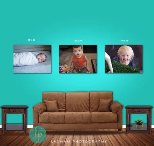 Wall Gallery with three pictures of babies on the wall with a light green background, with two side tables, a brown couch, and a wood floor