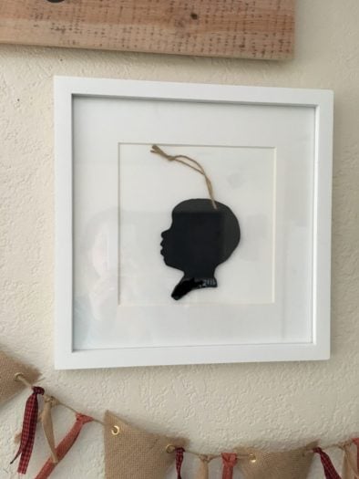 Silhouette Ornament of boy with white frame to wall