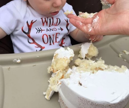 Feeding toddler boy white cake 