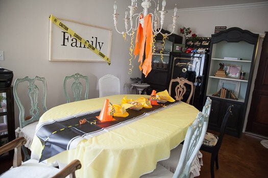 Road map with cones and caution tape on dining table party decorations