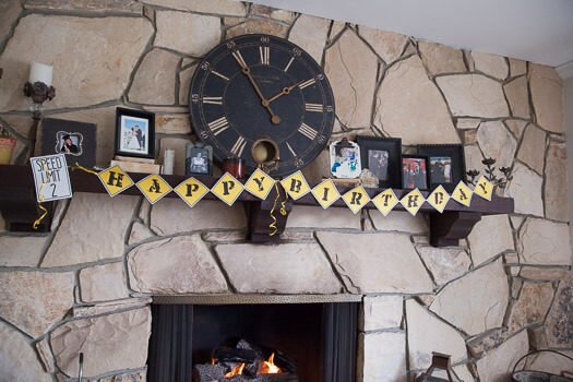 happy birthday banner hanging on shelf above fireplace 