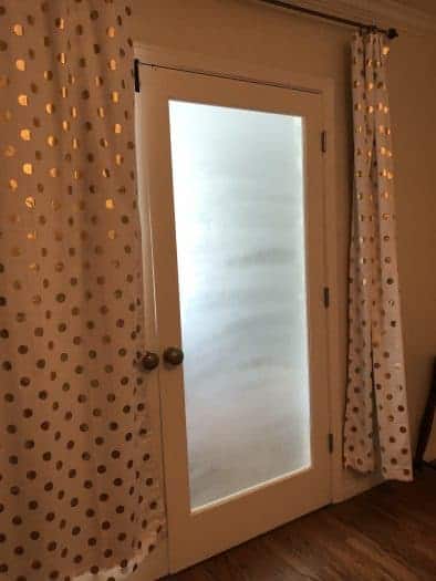 DIY frosted window with white and gold curtains around them