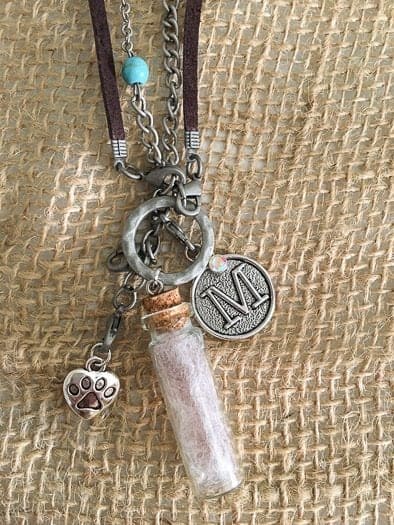 Pet memorial necklace with letter M pendant and paw charm and fur in capsule 