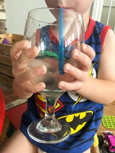 Halloween drink for kids - ghoulish lemonade held by toddler 