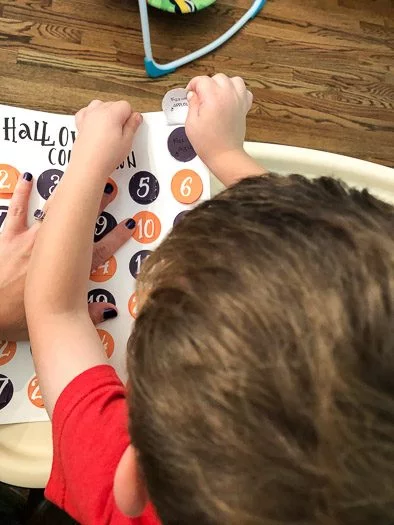Little boy looking at a halloween countdown