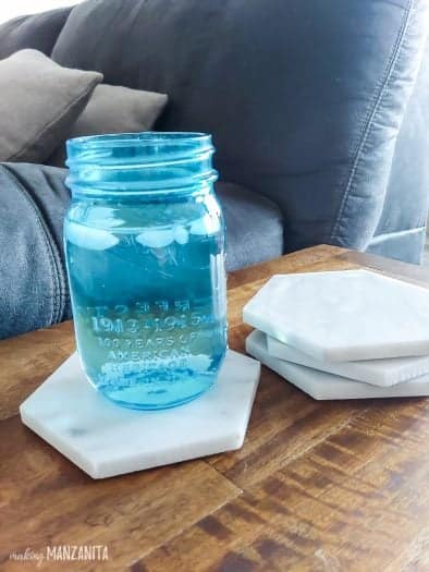 4 marble coasters with light blue mason jar on one of them the other 3 are stacked to the side  