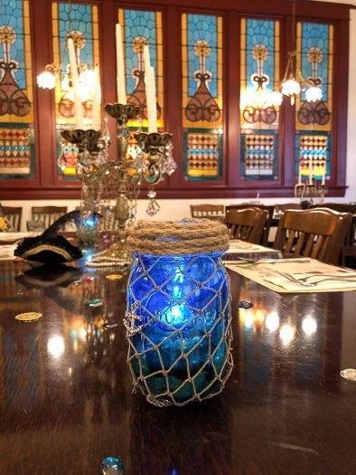 Fish net mason jar decoration centerpiece on dining table 