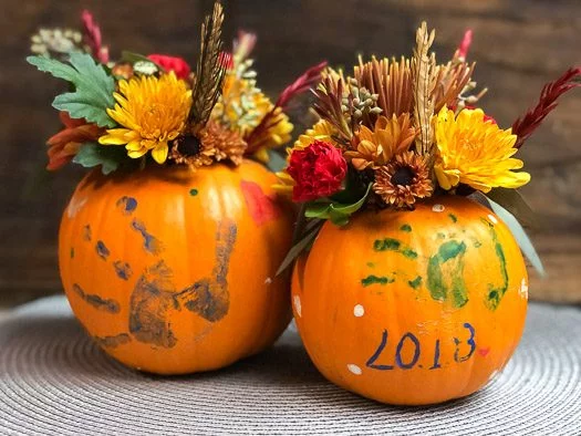  Painted pumpkins with fall flowers on top