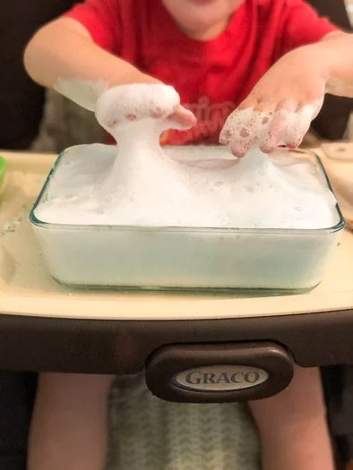 toddler playing with Super soapy dish 