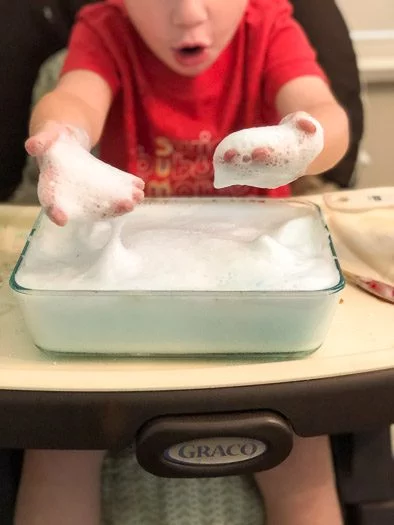 toddler holding sensory foam in hands