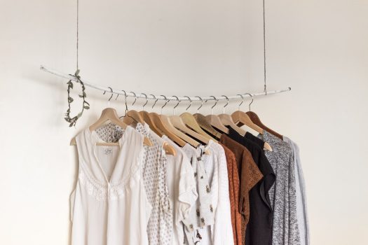 woman shirts hanging on a clothing rod