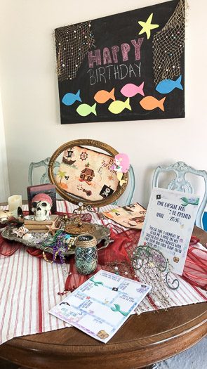 Mermaid and pirate party decorations on wall and dining table