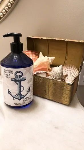 Sea shells and a blue nautical soap dispenser