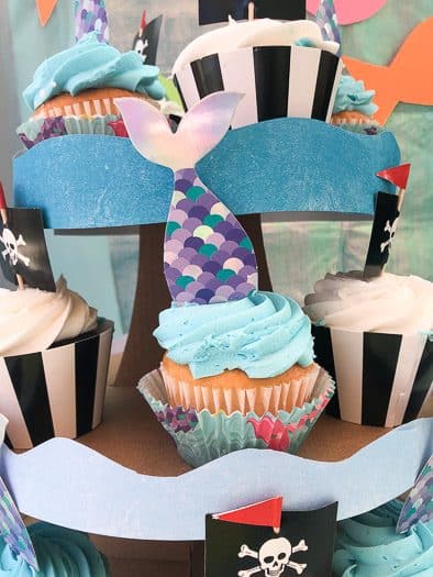 Mermaid and pirate party decorations including a blue and white cupcakes 