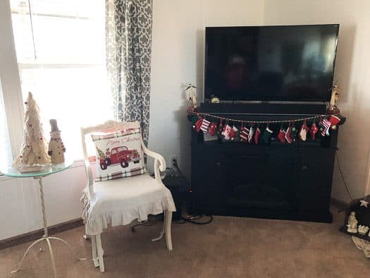 felt stockings hung under tv on tv stand fireplace