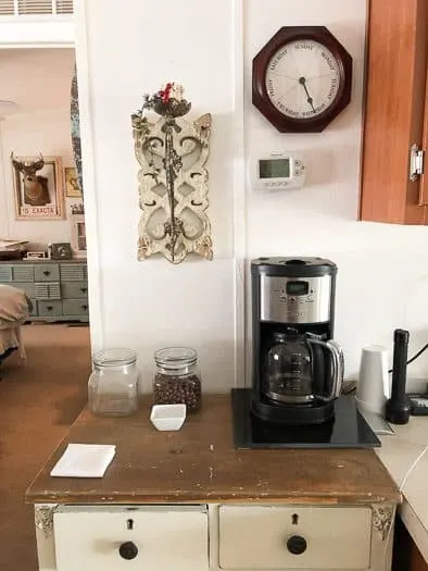 coffee station with antique clock on wall 