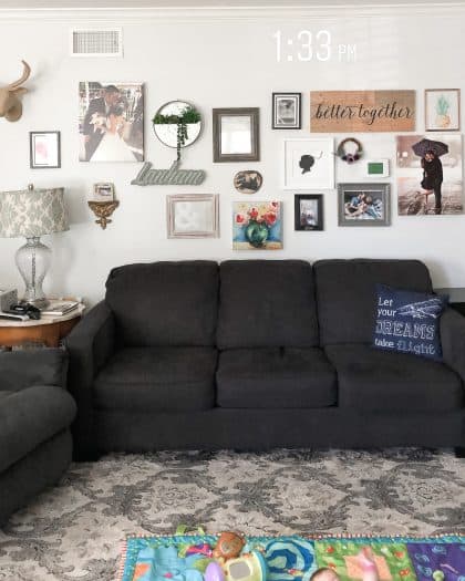 Wall filled with gallery items over a couch 