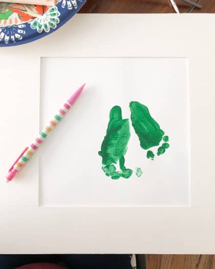 Green color painting of toddler feet 