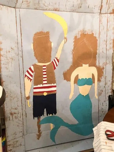 Painted over chalk drawing of pirate and mermaid 