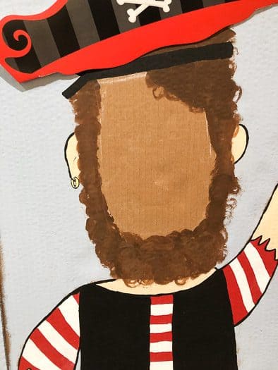 Painted in chalk drawing of pirate with red, black, and brown for the beard 