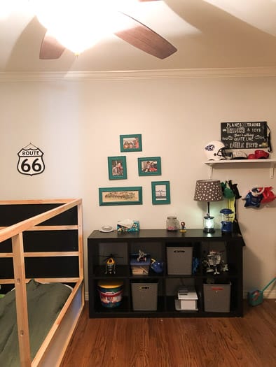 kids room with pictures on wall and a route 66 sign 