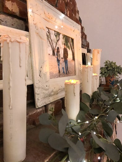 5 realistic flameless candles on overhang next to picture of family
