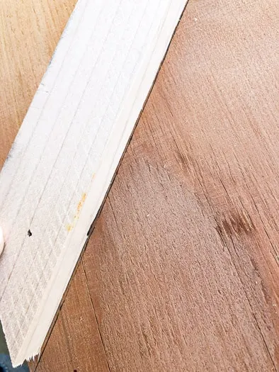 1x2 board fitting inside the pen line on the sanded plywood