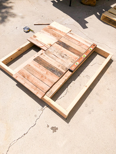 Pallet pieces laid out on top of the 2x4 base
