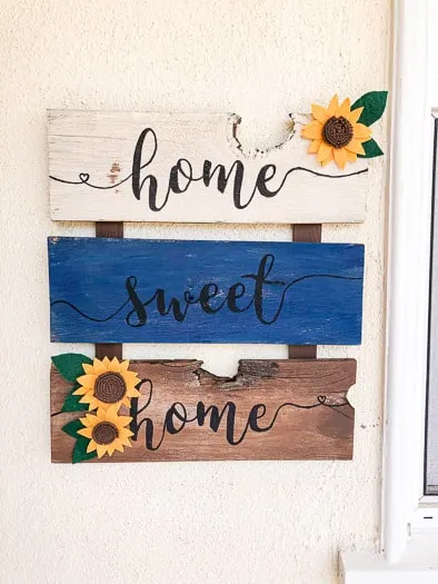 3 felt sunflowers on a sign that says home sweet home