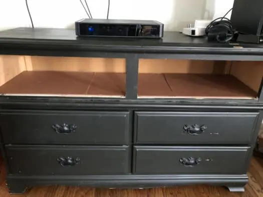 Black colored dresser with two top drawers out of it