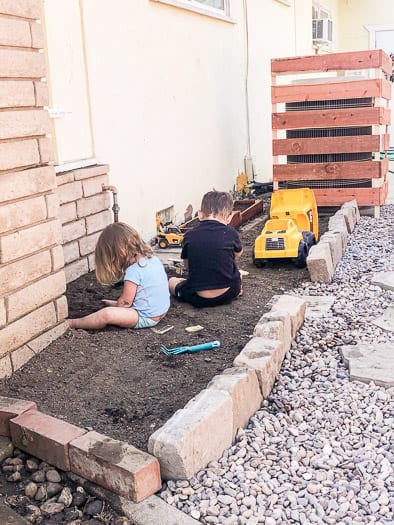 kids playing in a dirt area