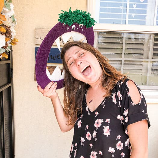 Woman pretending monster wreath is eating her head