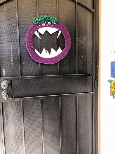 Monster Wreath on a black screen door