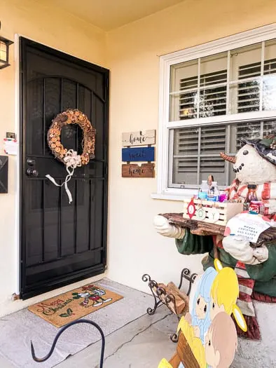 a porch with a dried fruit wreath on the front door