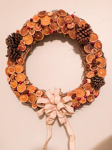 Dried fruit wreath with oranges, pinecones, and cranberries