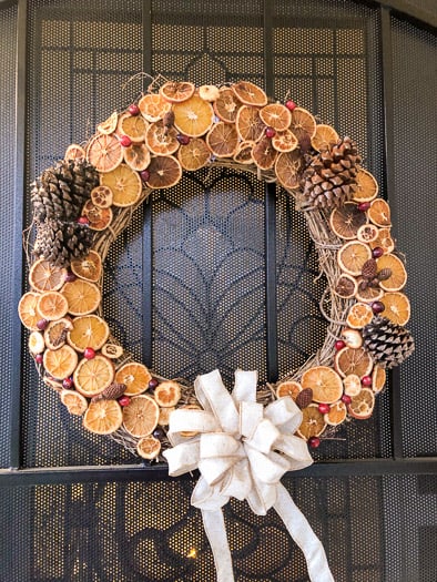 Dried fruit wreath with oranges, pinecones, and cranberries