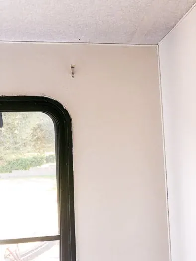 Window on left side, rest of the wall painted white.